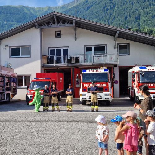 Vier Feuerwehrmänner und ihr Maskottchen Grisu