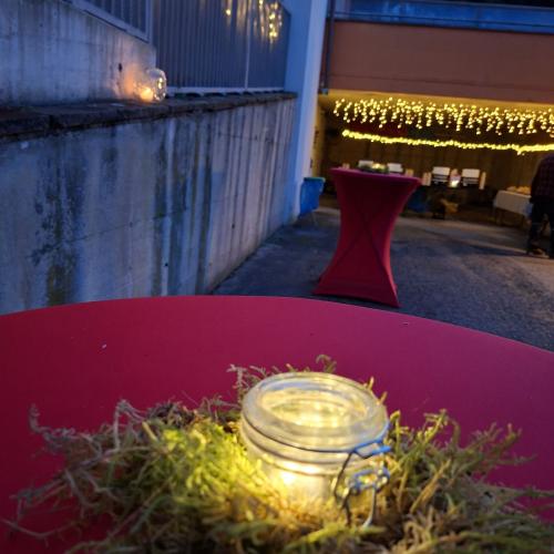 Die Stehtische sind  geschmückt mit einem Licht, welches in Moss eingebettet ist