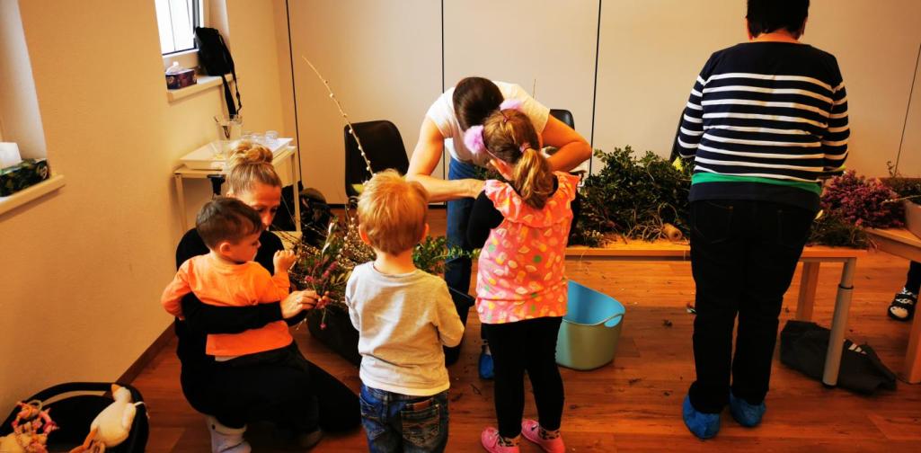 Verena Die Bäurinnen haben alle Utensilien für den Palmbusch auf Tischen hergerichtet und helfen den Kindern beim Binden der Palmbuschen